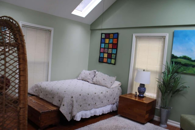 bedroom with vaulted ceiling with skylight