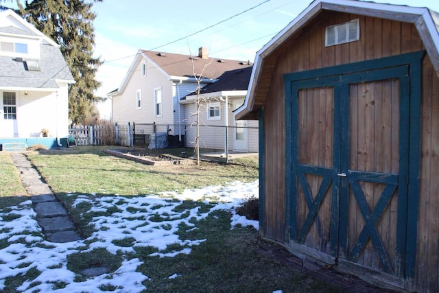 yard covered in snow featuring a storage unit