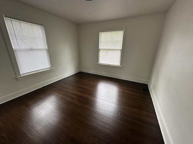 empty room featuring dark hardwood / wood-style flooring