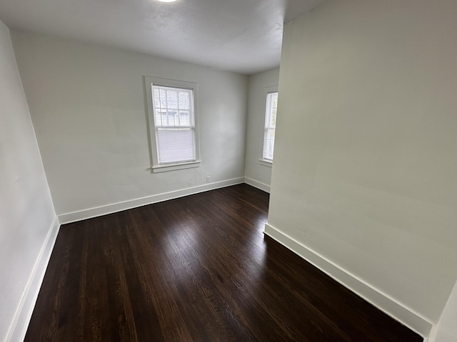 spare room featuring dark hardwood / wood-style flooring