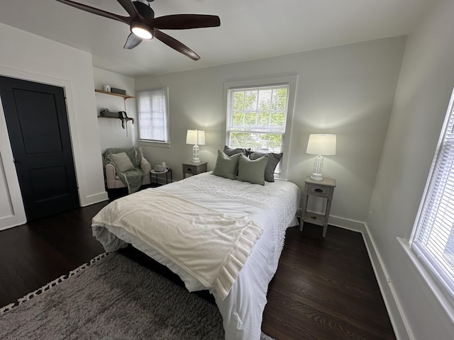 bedroom featuring multiple windows, ceiling fan, and dark hardwood / wood-style floors