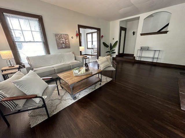 living room with dark hardwood / wood-style flooring