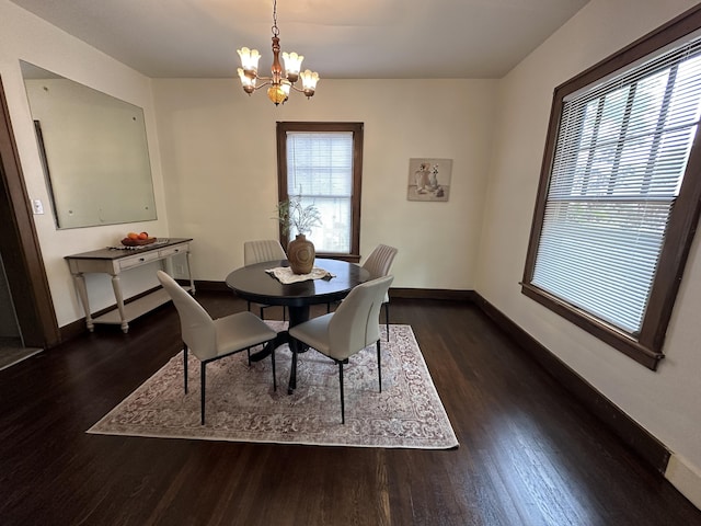 dining room with an inviting chandelier and dark hardwood / wood-style floors