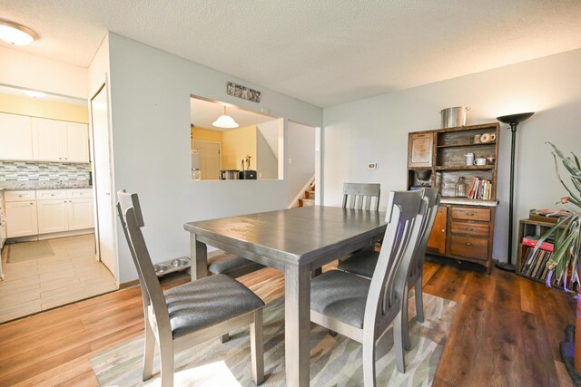 269 Blendon Rd, West Jefferson, OH 43162 - dining room with wood finished floors, stairway, and a textured ceiling