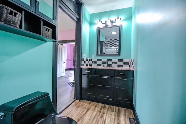 220 Williams St, Troy, OH 45373 - bathroom featuring backsplash, vanity, and wood finished floors
