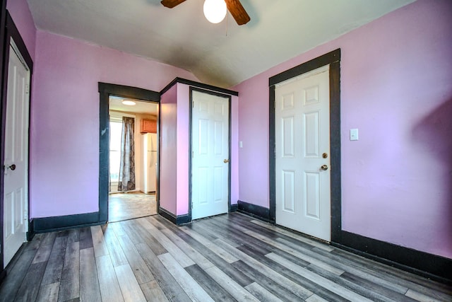 220 Williams St, Troy, OH 45373 - unfurnished bedroom with freestanding refrigerator, dark wood-style floors, a closet, a ceiling fan, and vaulted ceiling