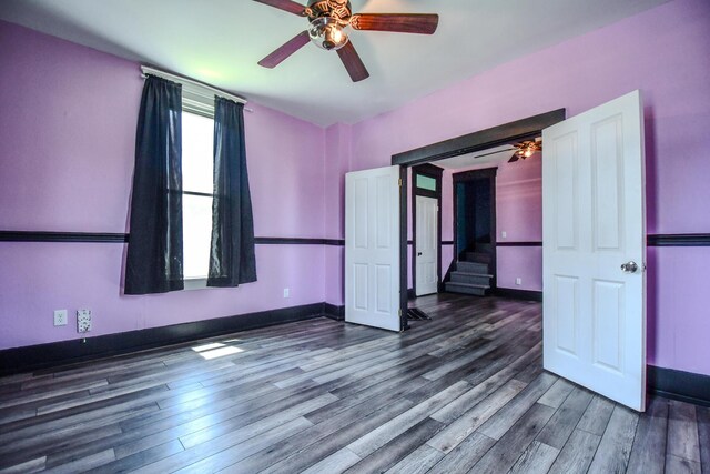 220 Williams St, Troy, OH 45373 - empty room featuring ceiling fan, wood finished floors, and stairway