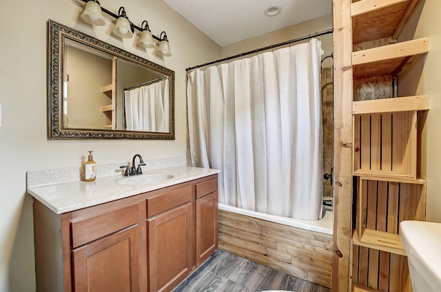 full bathroom featuring vanity, shower / bathtub combination with curtain, toilet, and wood finished floors