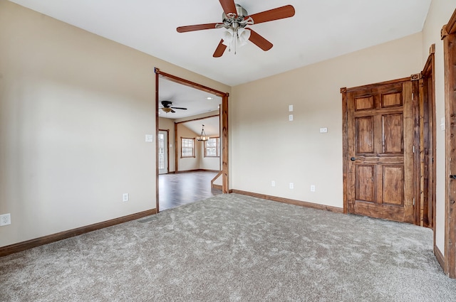 carpeted empty room with ceiling fan with notable chandelier, lofted ceiling, and baseboards