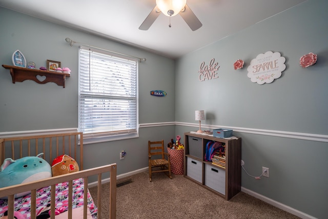 carpeted bedroom with visible vents, baseboards, and ceiling fan