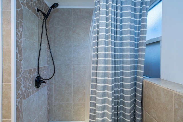 bathroom with tiled shower