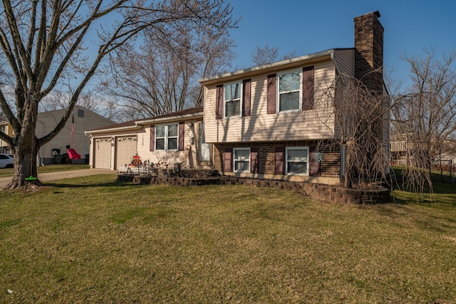 tri-level home featuring a garage, driveway, a front yard, and a chimney