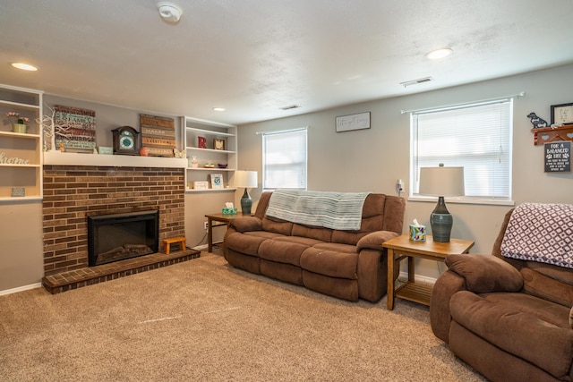 carpeted living room featuring recessed lighting, a fireplace, visible vents, and baseboards