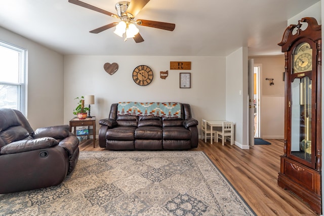 living room featuring wood finished floors and a ceiling fan