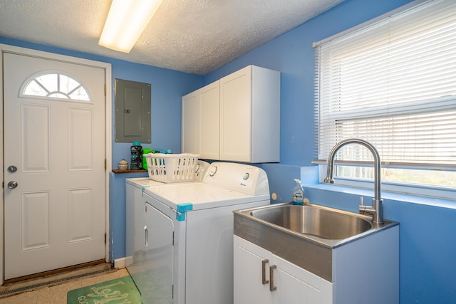 laundry room featuring washer and clothes dryer, electric panel, a sink, plenty of natural light, and cabinet space