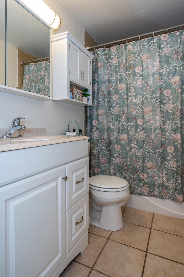 bathroom featuring tile patterned floors, toilet, and vanity