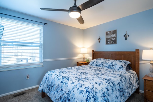 carpeted bedroom featuring visible vents, baseboards, and a ceiling fan