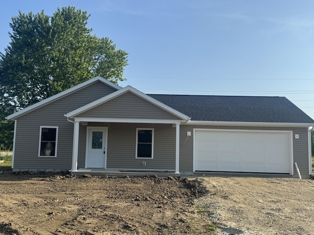 3865 Marne Dr, Saint Marys, OH 45885 - view of front of house with dirt driveway, a porch, a garage, and a shingled roof