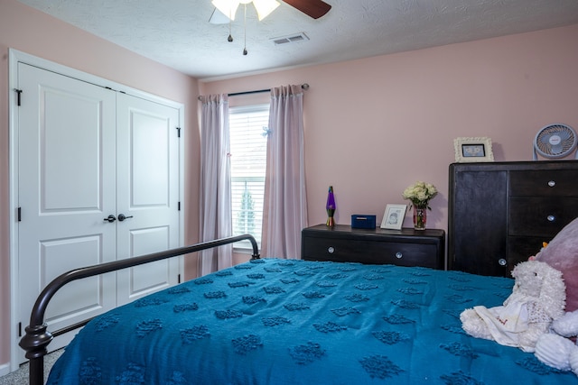 8754 Elysee Cir, Washington Twp, OH 45458 - carpeted bedroom featuring a closet, ceiling fan, and a textured ceiling