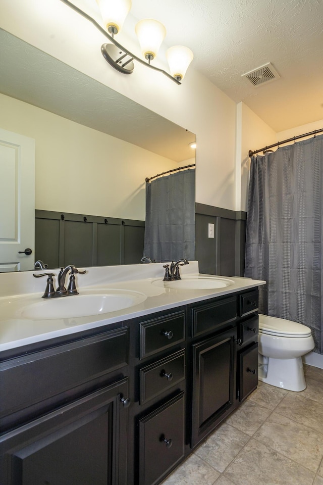 8754 Elysee Cir, Washington Twp, OH 45458 - bathroom featuring wainscoting, a decorative wall, double vanity, and a shower with shower curtain