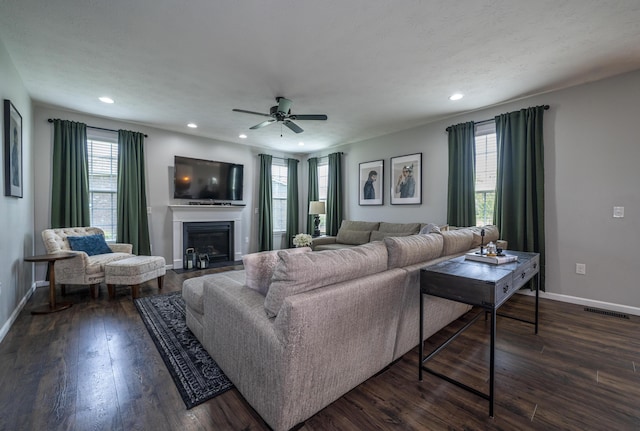 8754 Elysee Cir, Washington Twp, OH 45458 - living area featuring dark wood-style floors, plenty of natural light, a fireplace, recessed lighting, and ceiling fan