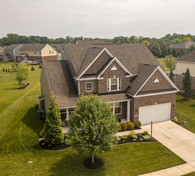 8754 Elysee Cir, Washington Twp, OH 45458 - view of front facade with brick siding, driveway, a garage, and a front yard