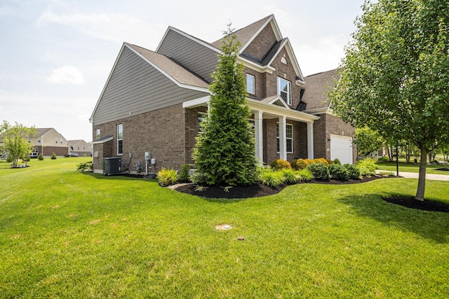 8754 Elysee Cir, Washington Twp, OH 45458 - view of side of home with brick siding, a lawn, a garage, and a shingled roof