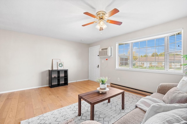 living area with ceiling fan, a baseboard radiator, light wood-style flooring, baseboards, and an AC wall unit