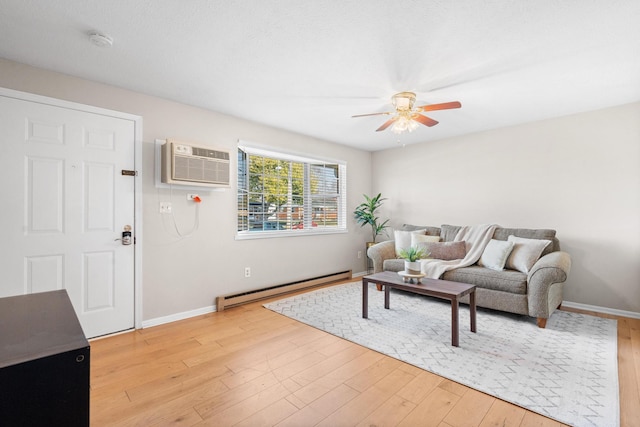 living area featuring light wood-style floors, ceiling fan, a baseboard heating unit, and an AC wall unit