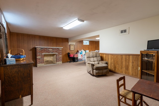 704 Campbell Rd, Sidney, OH 45365 - carpeted living room featuring a wainscoted wall, wooden walls, visible vents, and a brick fireplace