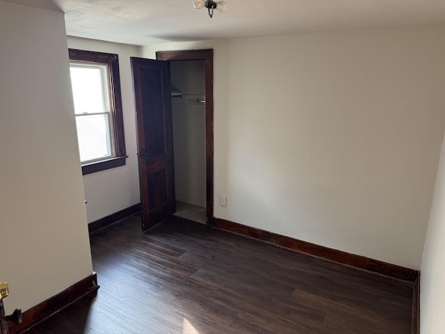 unfurnished room with dark hardwood / wood-style floors