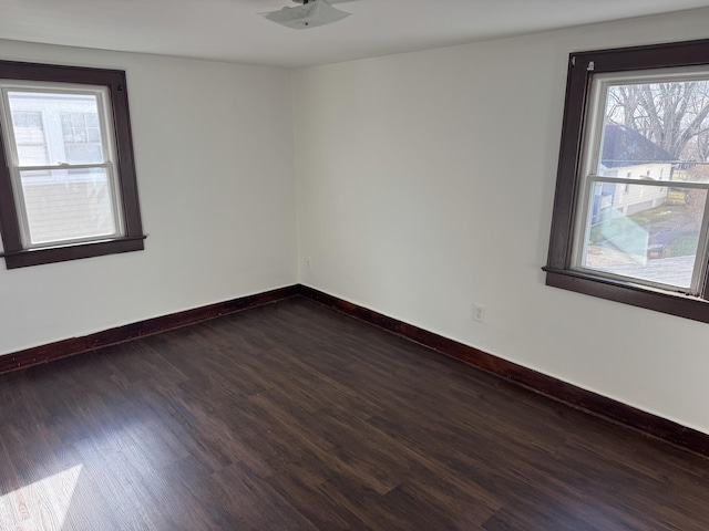 empty room with dark hardwood / wood-style floors