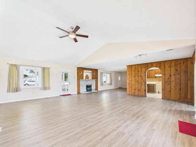 173 Front St, West Milton, OH 45383 - unfurnished living room with a stone fireplace, ceiling fan, light wood-style floors, and high vaulted ceiling