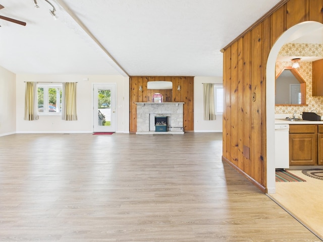 173 Front St, West Milton, OH 45383 - unfurnished living room with light wood-style floors, ceiling fan, and a stone fireplace