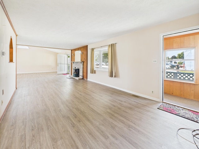 173 Front St, West Milton, OH 45383 - unfurnished living room with light wood finished floors and a fireplace with raised hearth