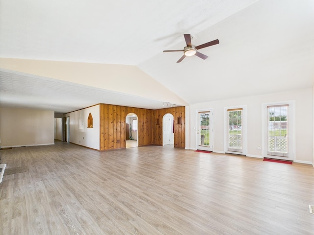 173 Front St, West Milton, OH 45383 - unfurnished living room with ceiling fan, light wood-style floors, arched walkways, high vaulted ceiling, and wooden walls