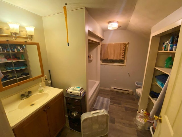 611 W Baird St, West Liberty, OH 43357 - full bath with a baseboard radiator, vanity, wood finished floors, lofted ceiling, and a bath