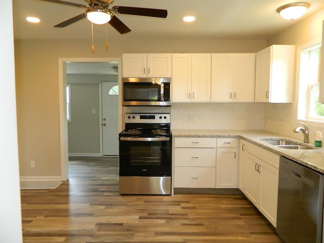 16 E Walnut St, Jeffersonville, OH 43128 - kitchen featuring stainless steel appliances, a sink, white cabinetry, light stone counters, and recessed lighting