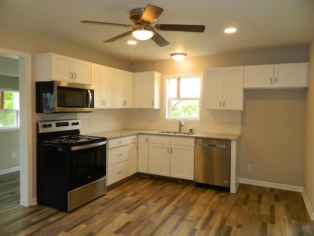 16 E Walnut St, Jeffersonville, OH 43128 - kitchen with stainless steel appliances, a sink, decorative backsplash, white cabinets, and recessed lighting