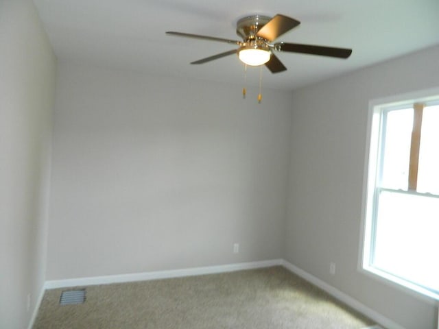 16 E Walnut St, Jeffersonville, OH 43128 - spare room featuring light carpet, ceiling fan, and baseboards