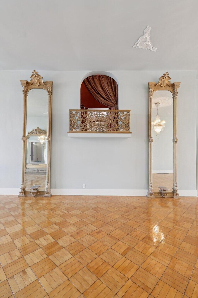 unfurnished living room featuring baseboards