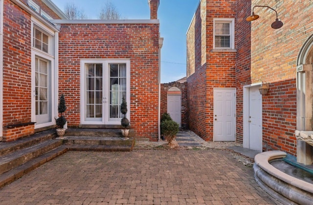 exterior space featuring entry steps and french doors