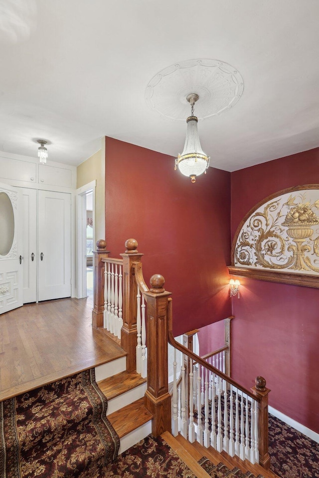 stairs featuring baseboards and wood finished floors