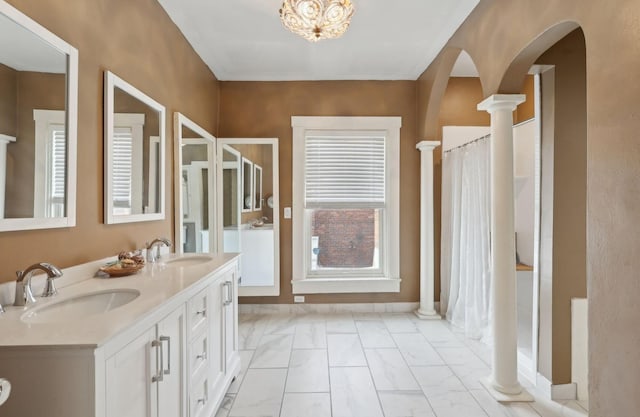 full bathroom with marble finish floor, a sink, and ornate columns