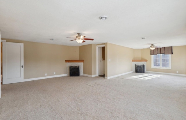 unfurnished living room featuring baseboards, ceiling fan, a fireplace, and light colored carpet