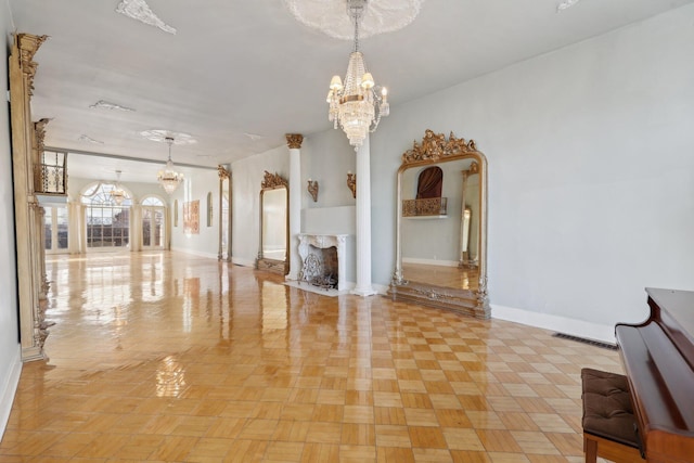 interior space featuring a chandelier, visible vents, and baseboards