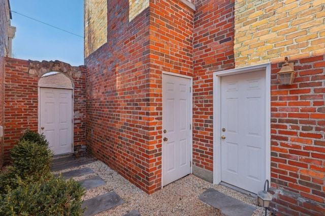 property entrance featuring brick siding