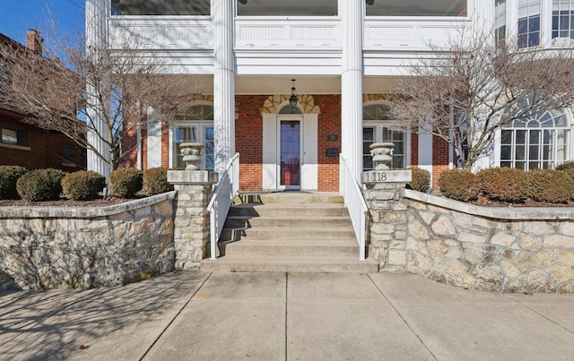 property entrance featuring brick siding