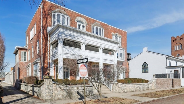 view of front of home featuring brick siding