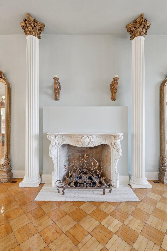 details with a high end fireplace, decorative columns, and baseboards